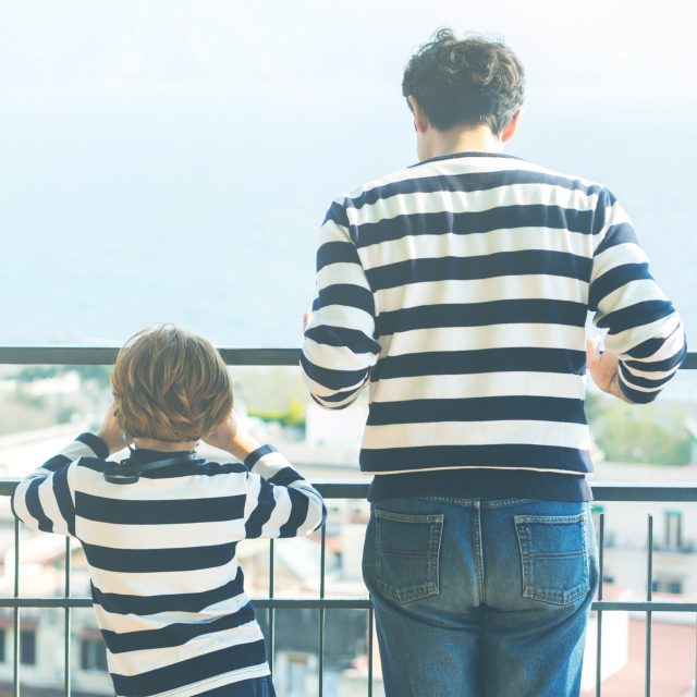 Father and son wearing striped shirts for family look. Fathers day concept