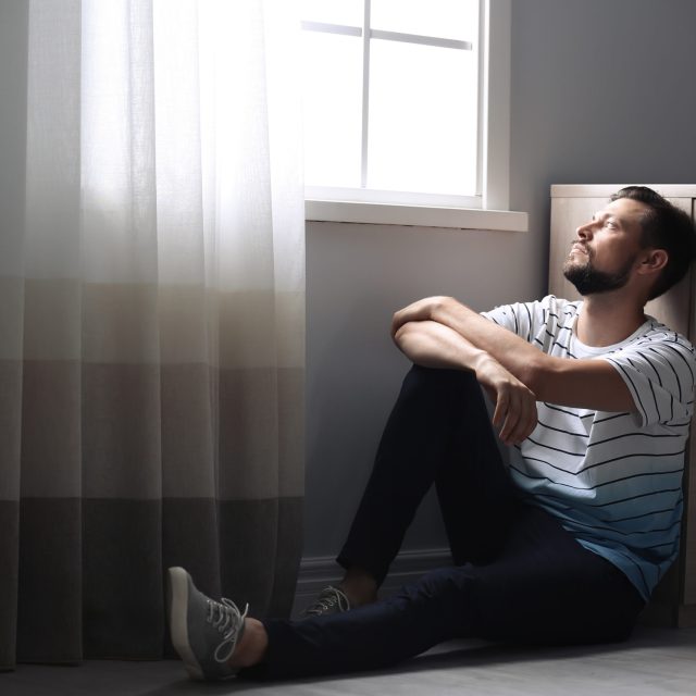 Lonely man suffering from depression at home