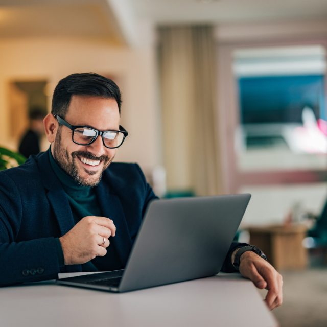 Positive businessman smiling at the home office.